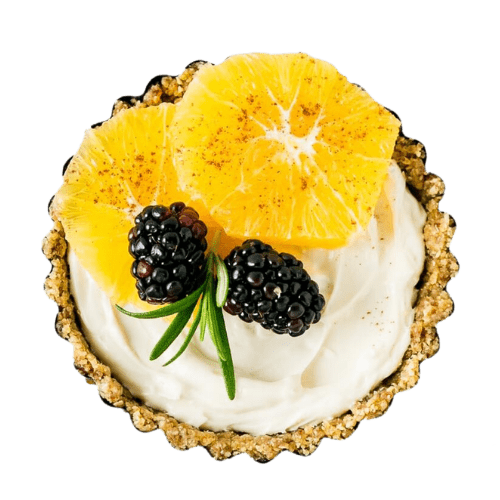fruit tart with cream, orange pieces and blackberries and a green twig