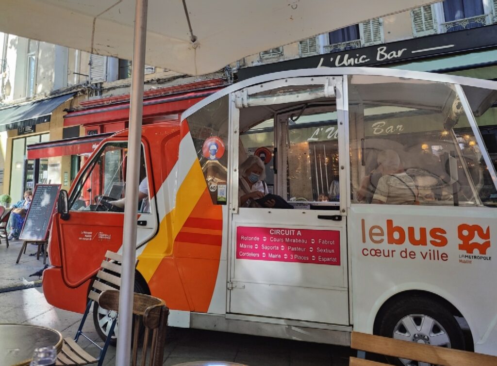 tiny electric bus in a narrow Aix-en-Provence street