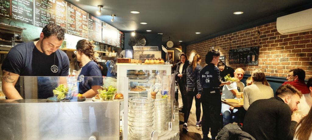 Inside Le Tuyau brunch restaurant in Aix, a busy atmosphere