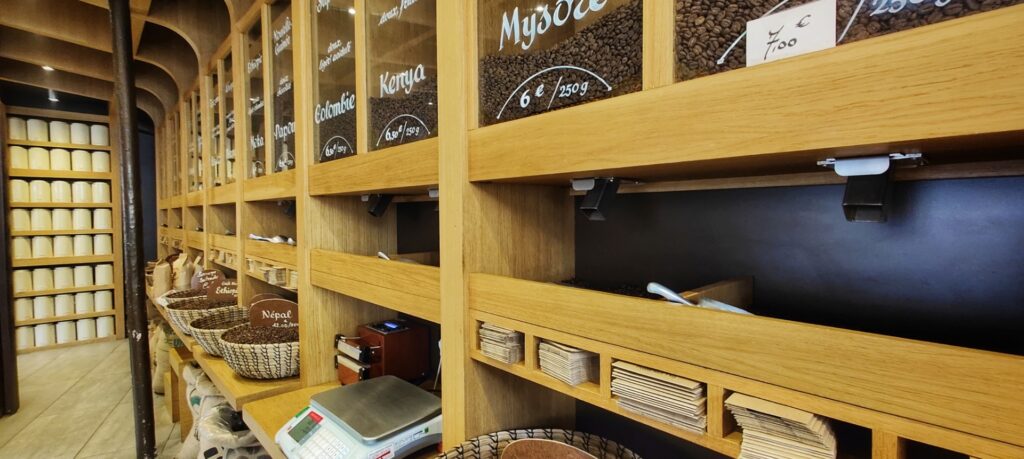 shelves with coffee beans and tea canisters in the background