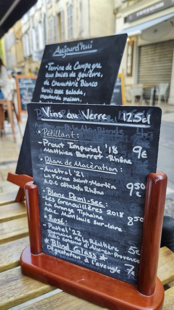 Black board menus with wine du jours written in French
