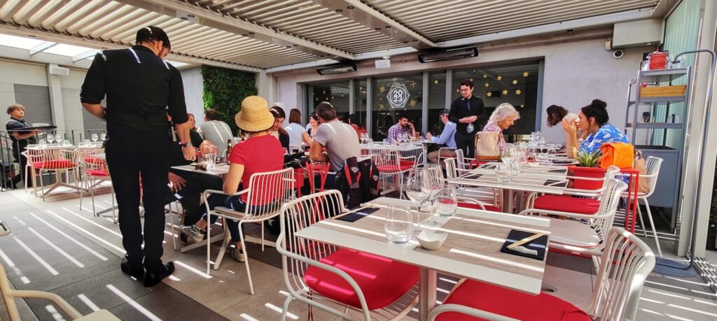 Outdoor covered patio at Restaurant sushi in Aix-en-Provence; diners enjoying their lunch.