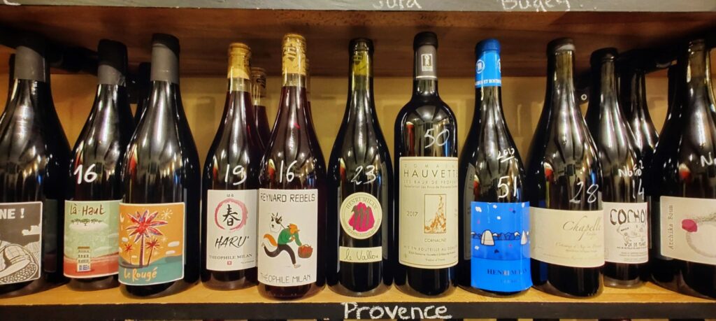 Shelf filled with bottles of wine labeled as Provence